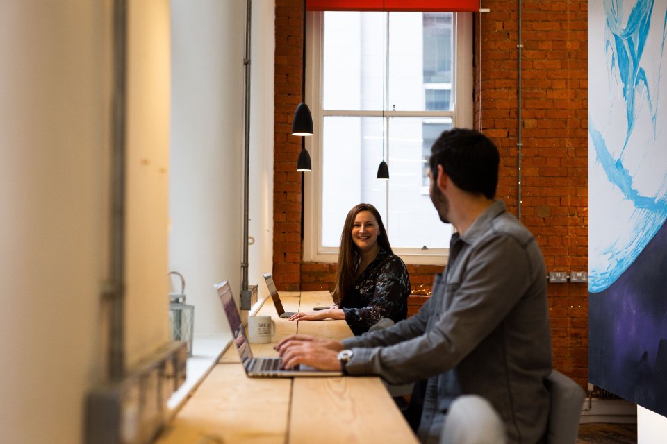 Team of 2 people collaborating at a dedicated desk