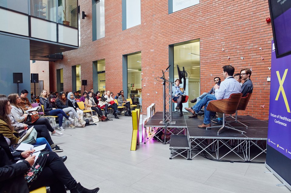 Group of people sat watching a MedX conference