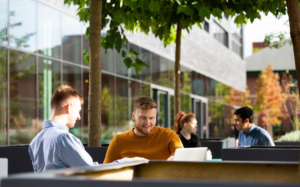 People working on outdoor tables