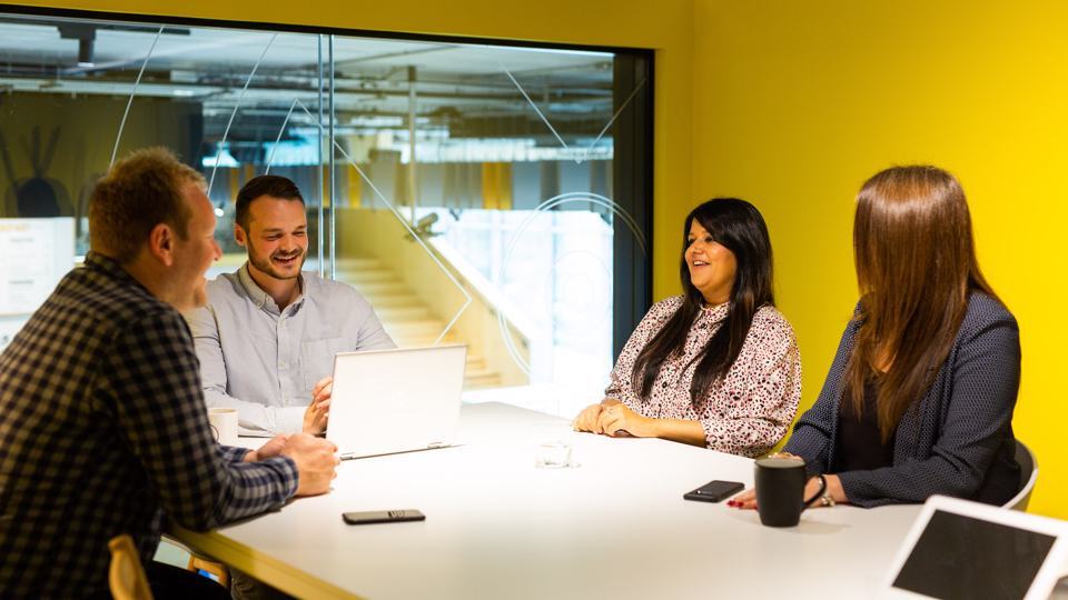 Group of people sat in a meeting room