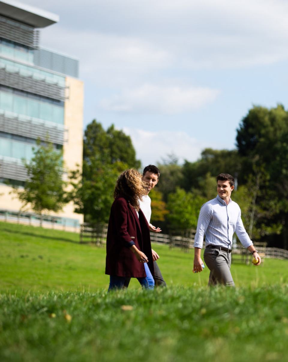 Group of people walking on the grass along Alderley Park