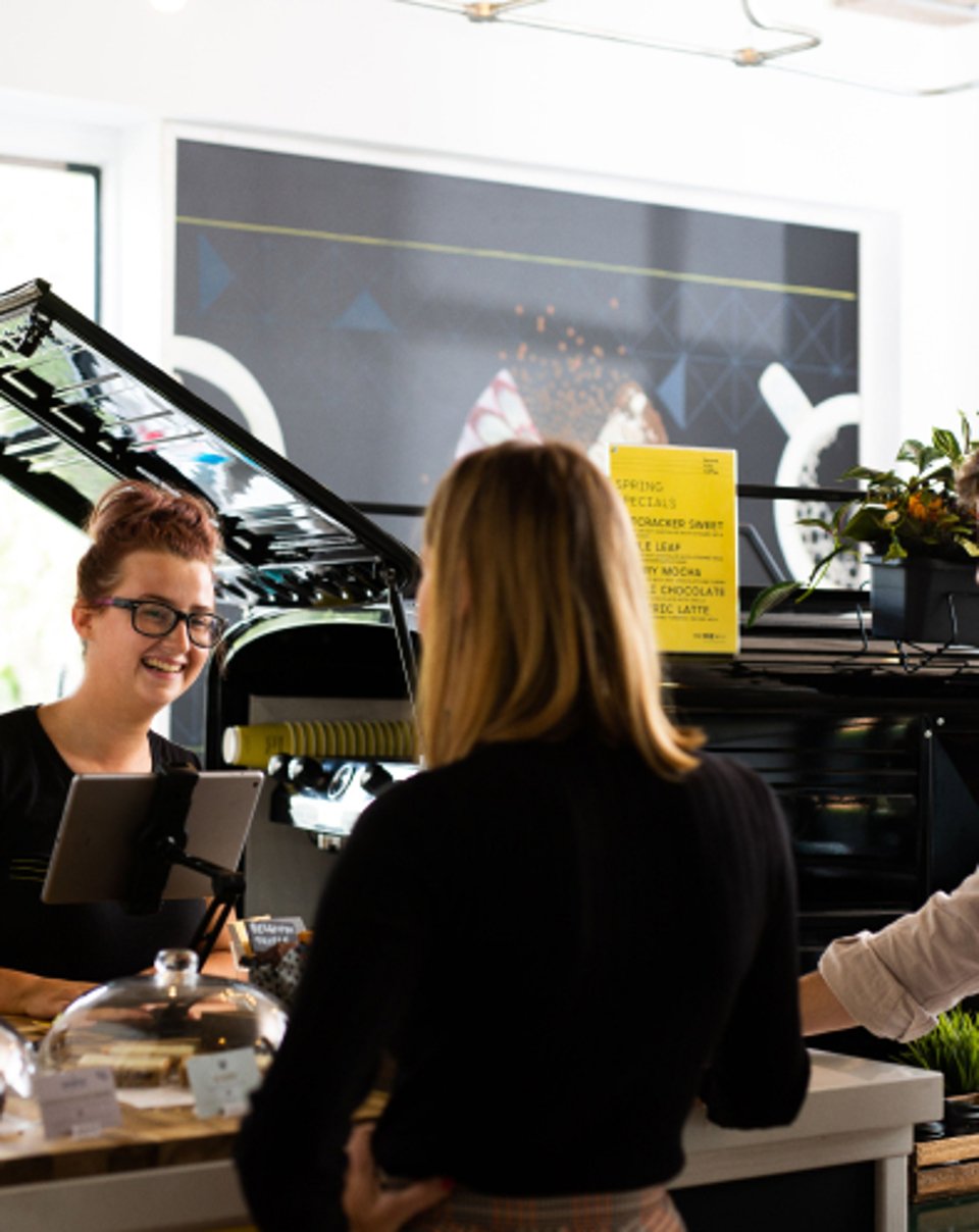 Customer ordering from a cafe counter