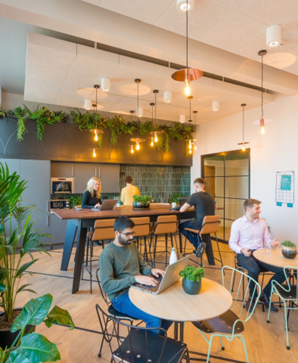 People scattered at different tables in an openspace