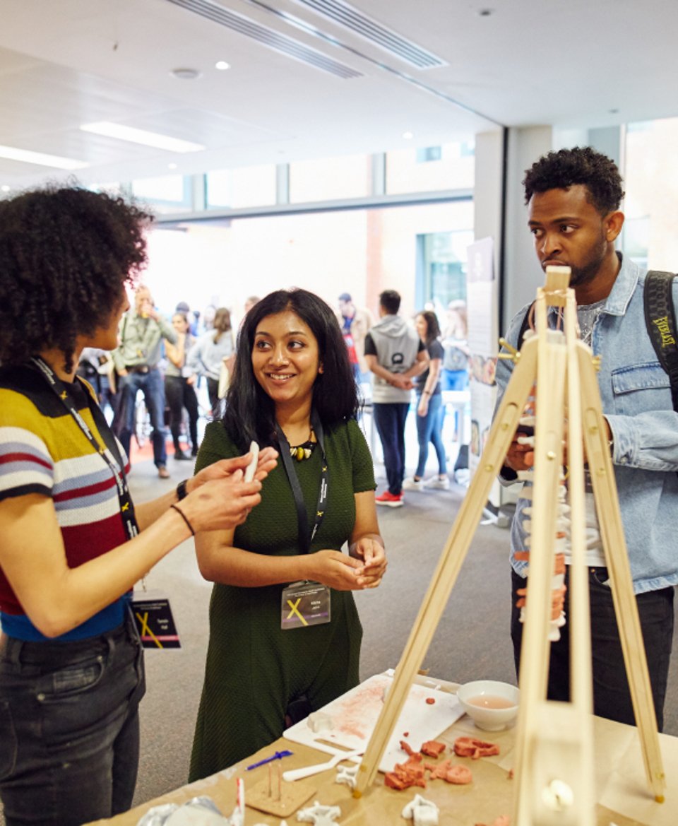 Group of people having a discussion around an apparatus at a CityLabs event