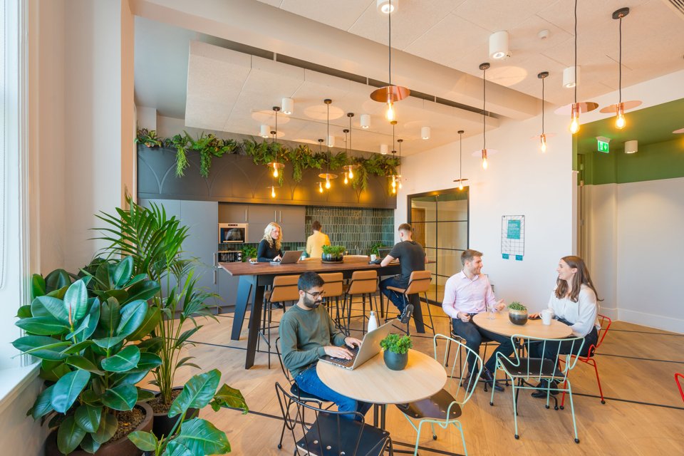 People sat at different tables in a Bruntwood open space