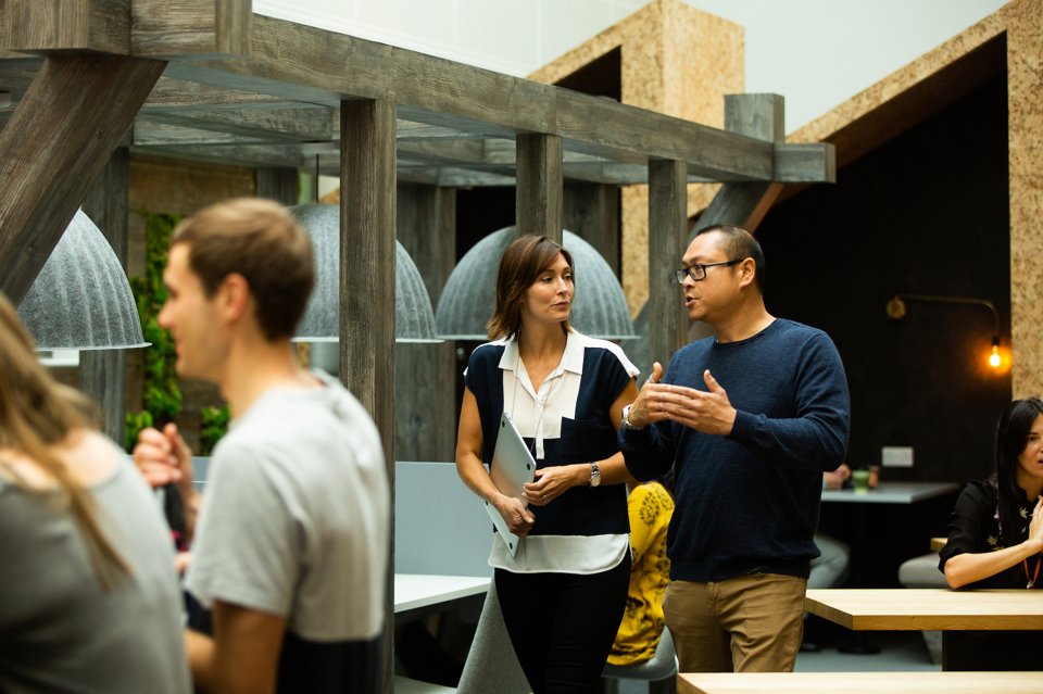 A Man and a woman walking along the Alderley Park canteen having a conversation