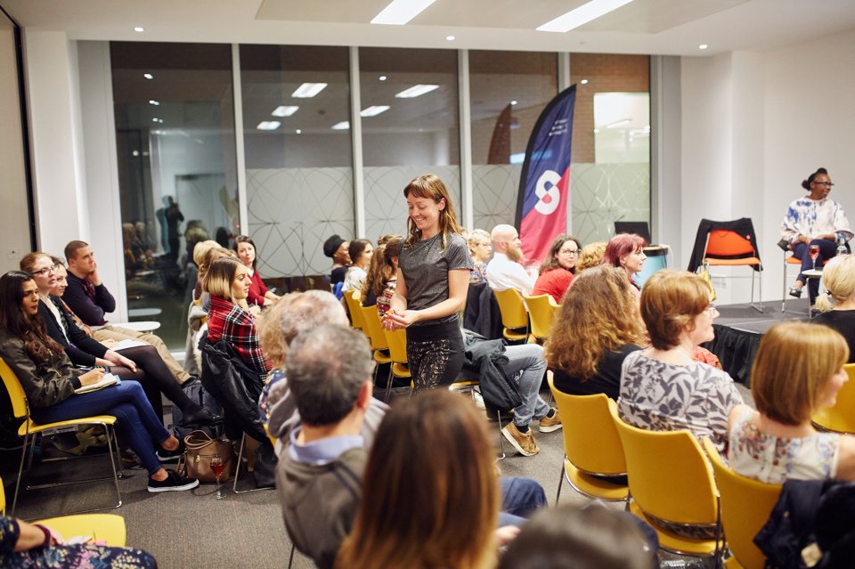 A Citylabs conference room full of people seated and intently watching a female talking about something