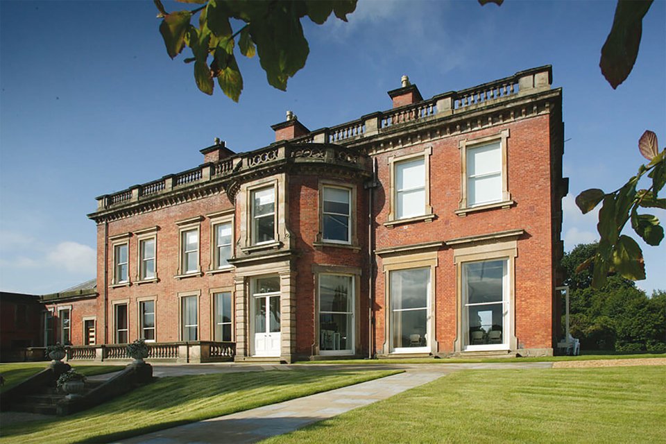 Outside look at the front of the booths park building surrounded by tress and grass