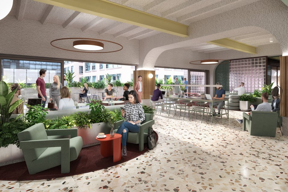 Inside look at a large social and work area inside the plaza building with people sat drinking coffee, working and collborating