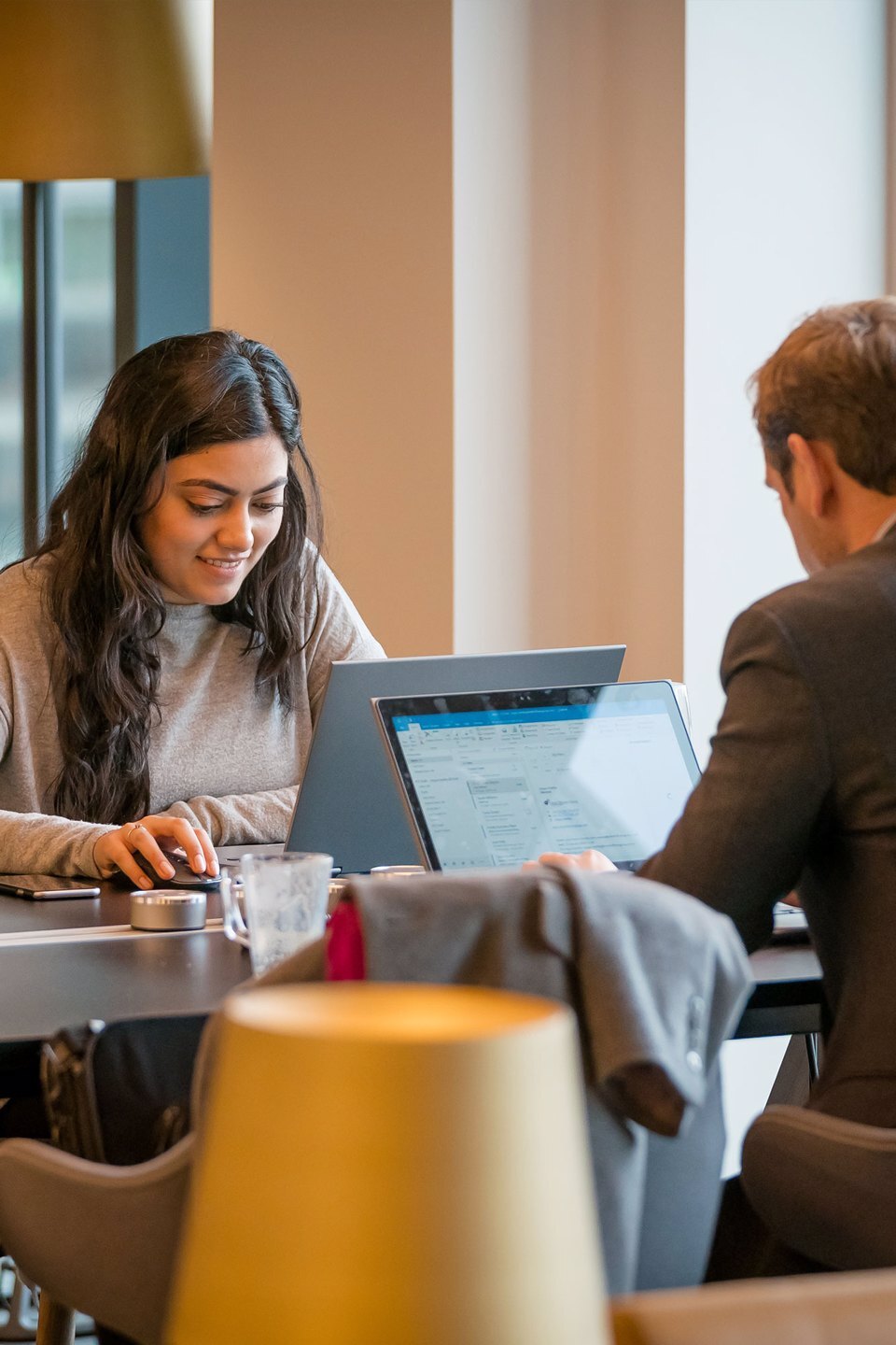 2 coworking on a low table in a large open area at Platform