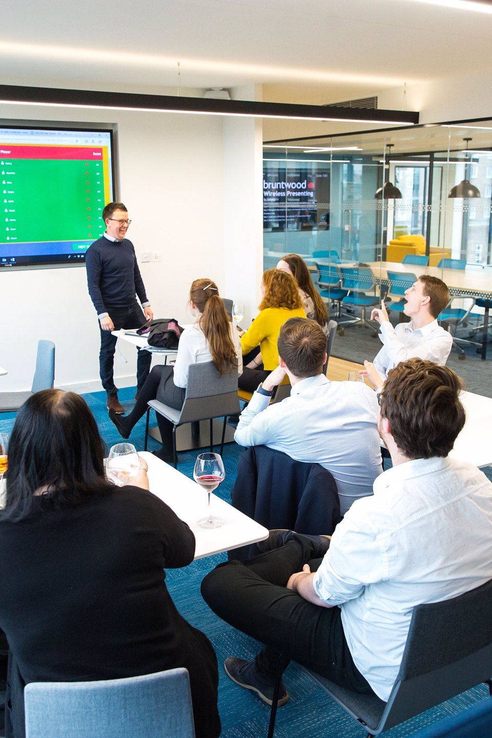 A group of people sat working together in a meeting room at Platform